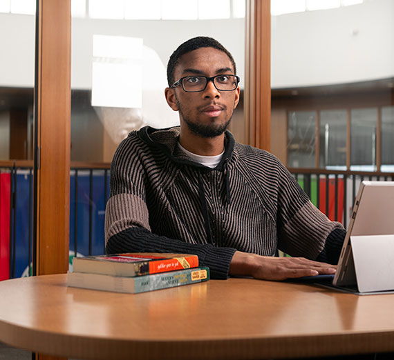 Gonzaga Senior Maalik Brown, Computer Science major, sitting at a table.